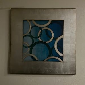 A silver, and blue wall decor.